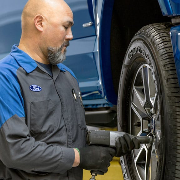  A Technician is Performing Brake Maintenance Services at Havana Ford Showroom in Florida