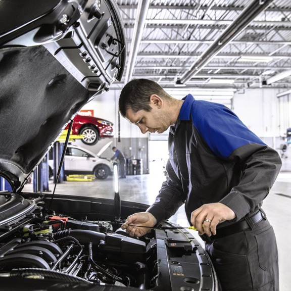A Technician is Performing Oil Replacement Services at Havana Ford Showroom in Florida